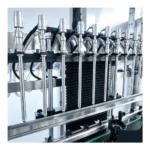 Close-up of 10 filling heads for peanut oil bottling